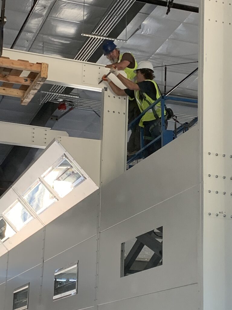 Workers installing a steel beam.