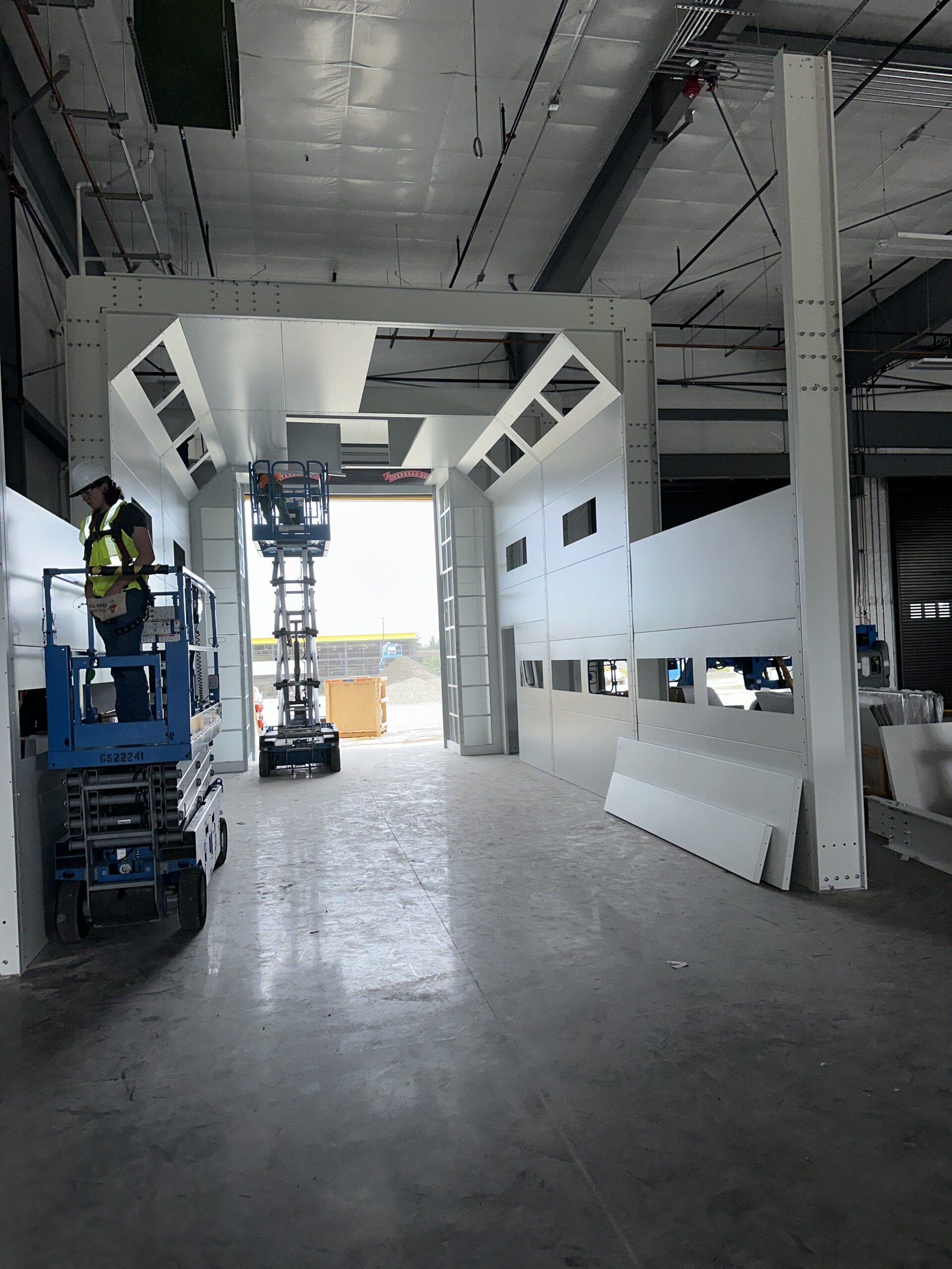 Workers installing an industrial paint booth.